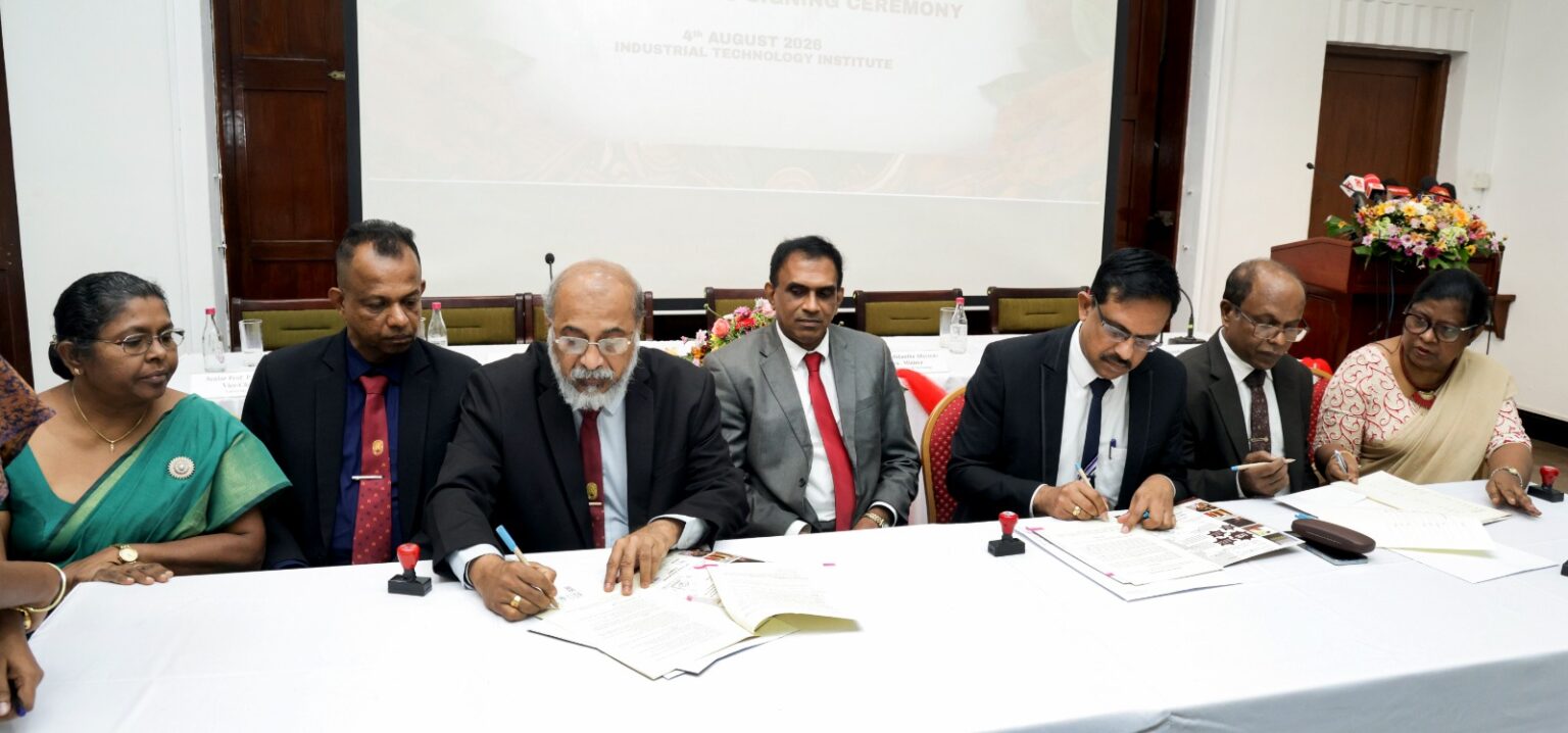 Sri Lankan researchers and scientists collaborating around a table reviewing agricultural biotechnology data